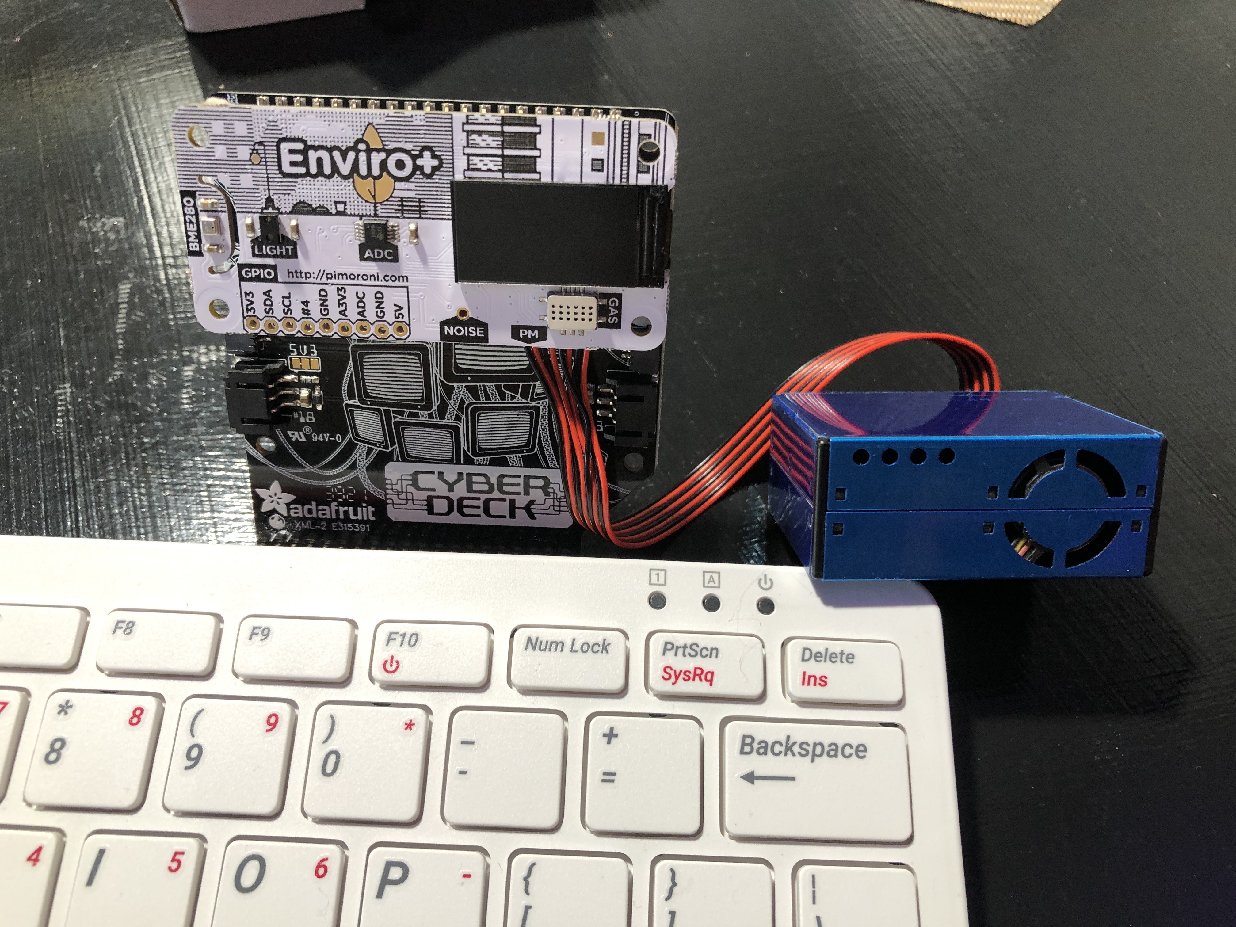Plug the Cyberdeck with the EnviroPlus and PMS5003 into the GPIO Pins of the RPi400